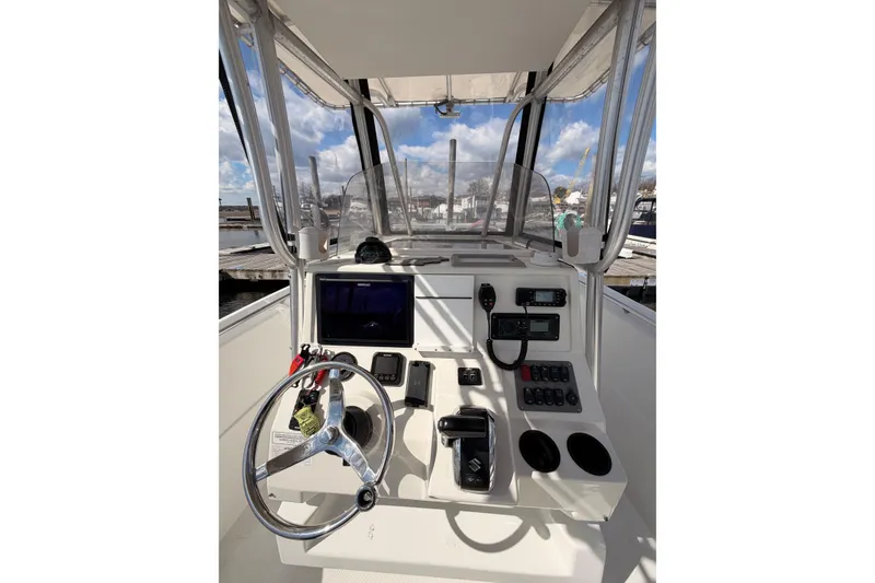 Slide: The Image of 2005 Sailfish 236 CC boat cockpit with steering wheel and navigation controls. - 6