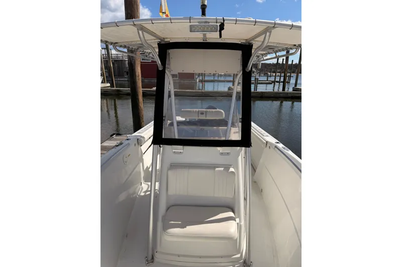 Slide: The Image of 2005 Sailfish 236 CC boat with center console and seating, docked at a marina. - 7