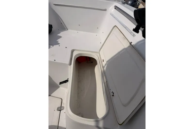 Slide: The Image of Open storage compartment on a 2005 Sailfish 236 CC boat deck. - 9