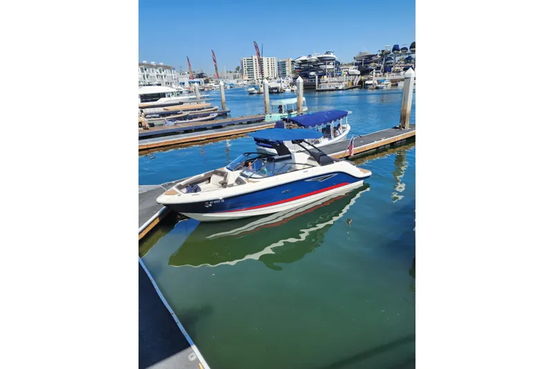 Slide: The Image of 2017 25' Sea Ray 250 SLX boat docked in a marina under clear blue skies. - 4