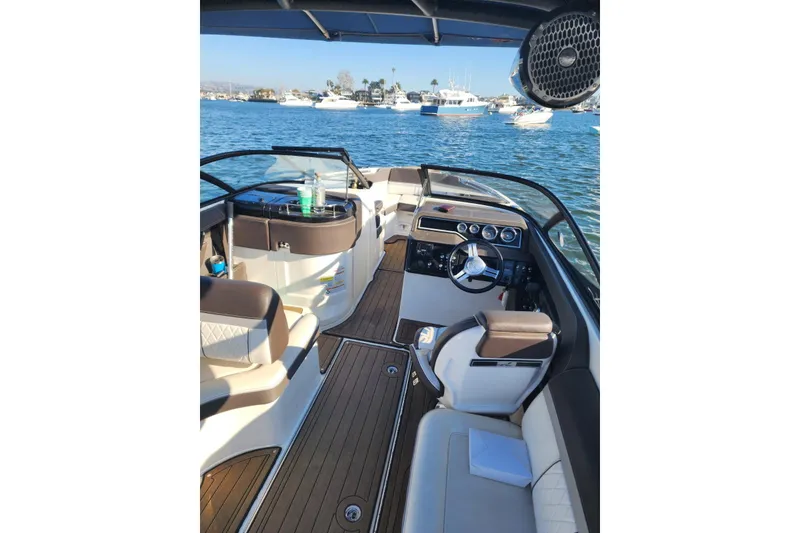Slide: The Image of 2017 Sea Ray 250 SLX boat interior with luxurious seating and modern dashboard on the water. - 5