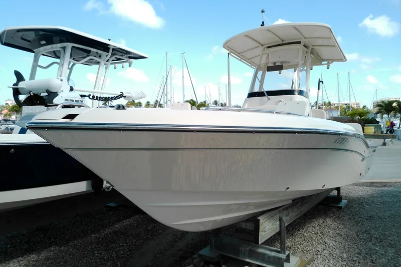 The Image of 2015 Grady-White 251 Coastal Explorer boat docked at marina under blue sky. - 1