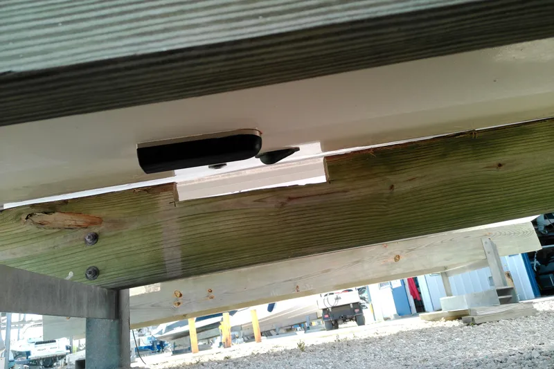 Slide: The Image of 2015 Grady-White 251 Coastal Explorer boat underside on wooden support. - 10