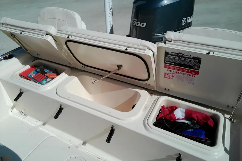 Slide: The Image of 2015 Grady-White 251 Coastal Explorer boat storage compartments with Yamaha engine in background. - 14