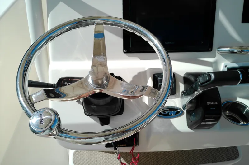 Slide: The Image of Steering wheel and controls of 2015 Grady-White 251 Coastal Explorer boat. - 21