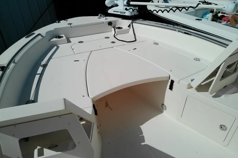Slide: The Image of 2015 Grady-White 251 Coastal Explorer boat deck with storage compartments and seating area. - 27