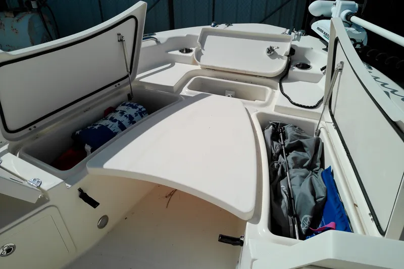 Slide: The Image of 2015 Grady-White 251 Coastal Explorer boat storage compartments open, revealing gear and equipment. - 30