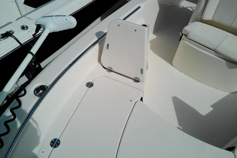 Slide: The Image of 2015 Grady-White 251 Coastal Explorer boat interior with seating and storage compartments. - 38