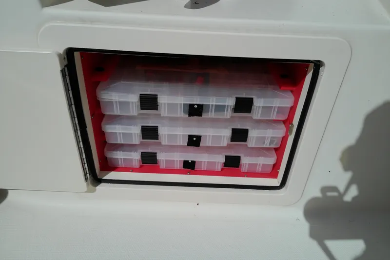 Slide: The Image of Storage compartment with tackle boxes on a 2015 Grady-White 251 Coastal Explorer boat. - 42