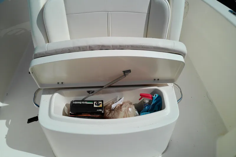 Slide: The Image of Storage compartment on a 2015 Grady-White 251 Coastal Explorer boat, open with items inside. - 43