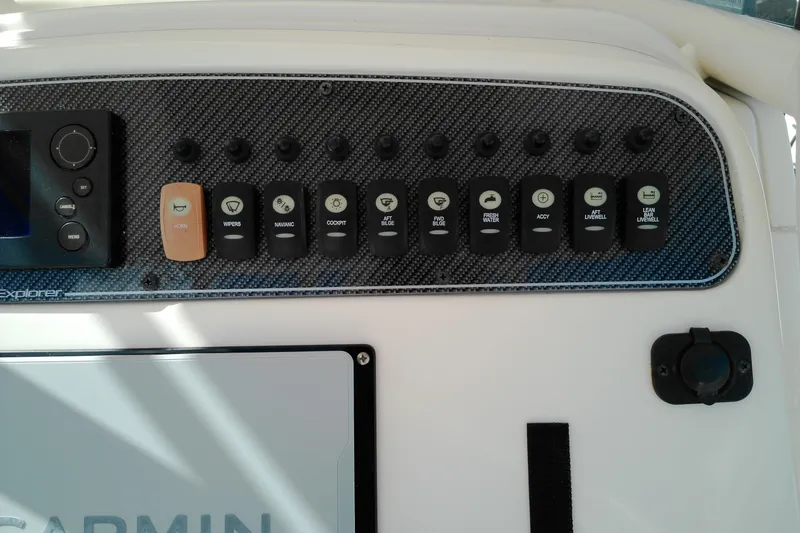 Slide: The Image of Control panel of 2015 Grady-White 251 Coastal Explorer boat with various switches. - 45