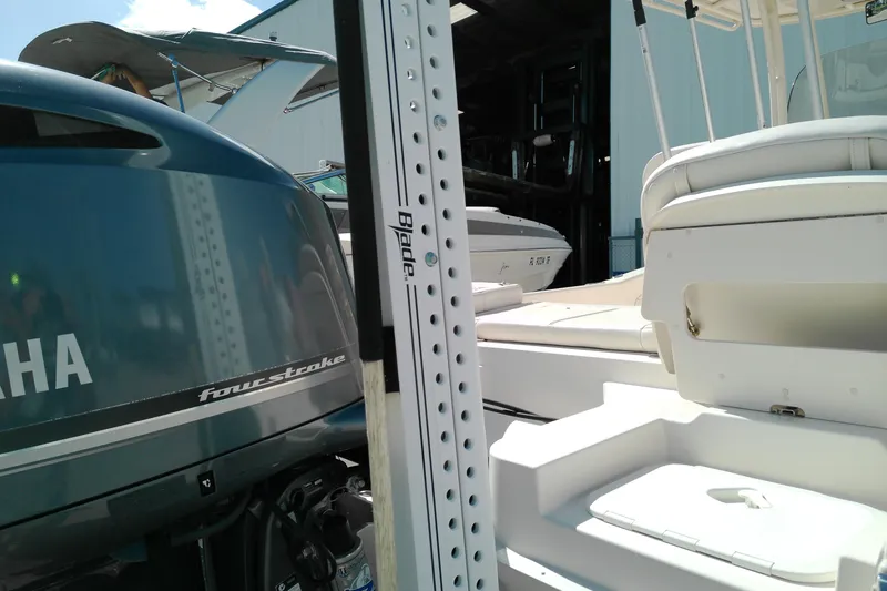 Slide: The Image of 2015 Grady-White 251 Coastal Explorer with Yamaha four-stroke engine, docked near other boats. - 7