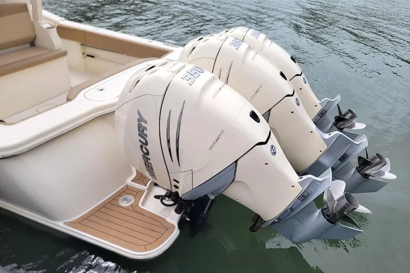 Slide: The Image of 2018 Scout 355 LXF boat with triple Mercury outboard engines on water. - 13