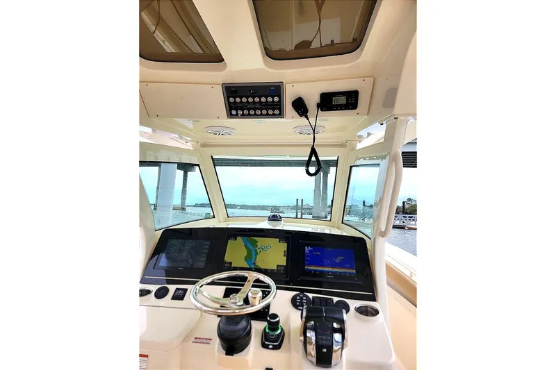 Slide: The Image of 2018 Scout 355 LXF boat dashboard with navigation screens and controls. - 15