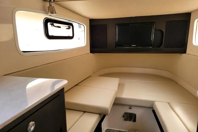 Slide: The Image of Luxurious interior cabin of 2018 Scout 355 LXF boat with seating and TV. - 22