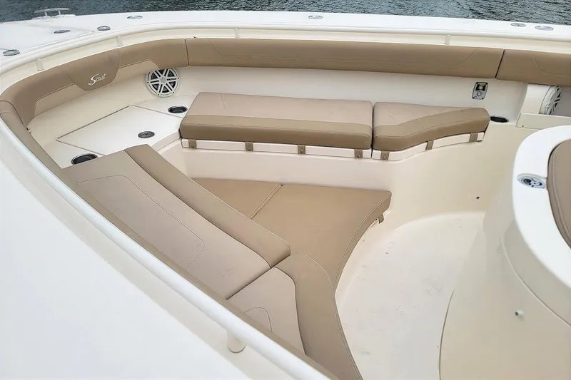 Slide: The Image of 2018 Scout 355 LXF boat interior with beige seating and speaker detail. - 29