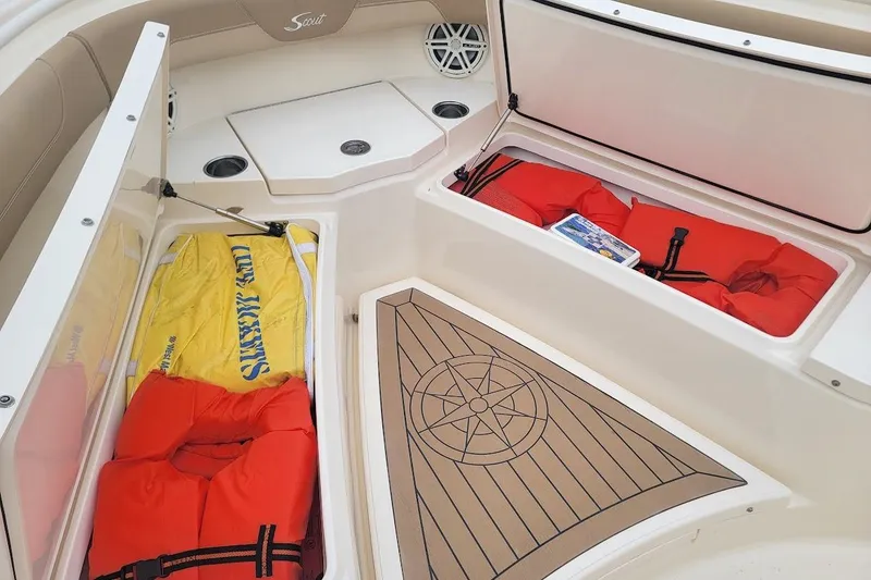 Slide: The Image of 2018 Scout 355 LXF boat interior with life jackets and storage compartments. - 31