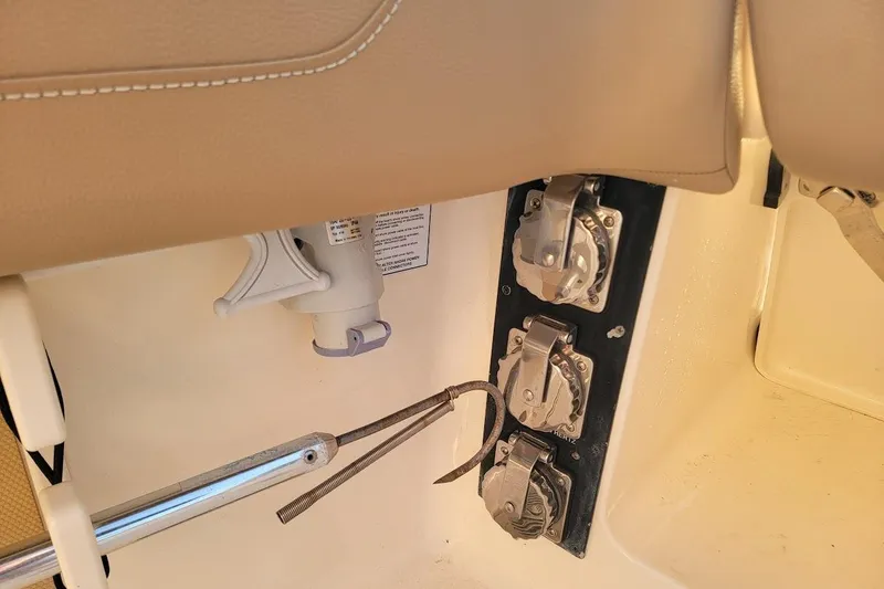 Slide: The Image of 2018 Scout 355 LXF boat interior showing utility panel and seating details. - 34