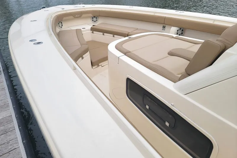 Slide: The Image of 2018 Scout 355 LXF boat interior with beige seating and sleek design. - 4