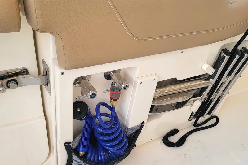 Slide: The Image of 2018 Scout 355 LXF boat interior with hose storage and utility features. - 43