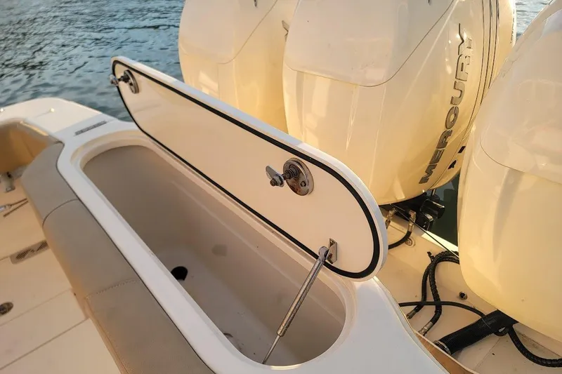 Slide: The Image of 2018 Scout 355 LXF boat with open storage compartment and Mercury engines. - 45