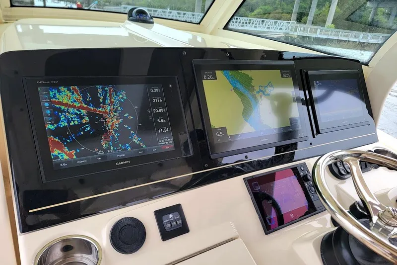 Slide: The Image of Control panel of a 2018 Scout 355 LXF boat with navigation displays. - 9