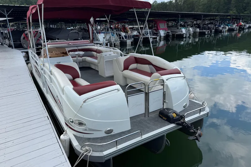 Slide: The Image of 2007 JC SunToon 23TT pontoon boat docked at marina with red canopy. - 2