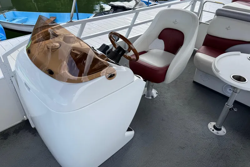 Slide: The Image of 2007 JC SunToon 23TT boat interior with helm, captain's chair, and table. - 4