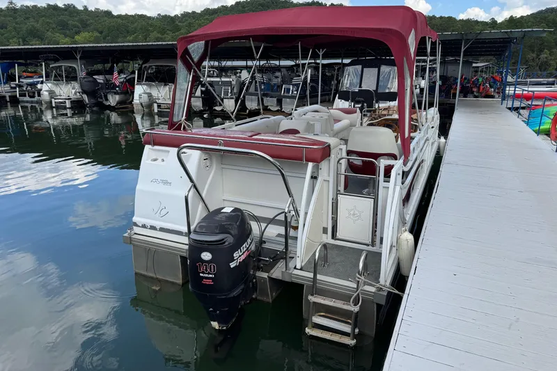 Slide: The Image of 2007 JC SunToon 23TT pontoon boat docked with red canopy and Suzuki 140 outboard motor. - 6