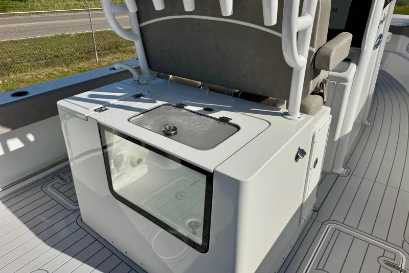 Slide: The Image of 2024 Sea Hunt Gamefish 28 Coffin Box interior, featuring seating and storage on deck. - 10