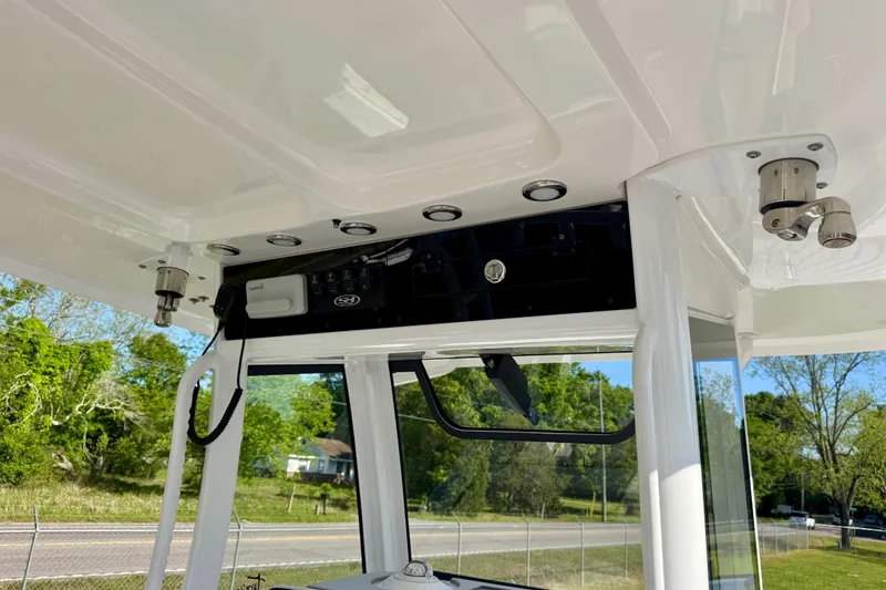 Slide: The Image of 2024 Sea Hunt Gamefish 28 Coffin Box boat console with electronic controls. - 12