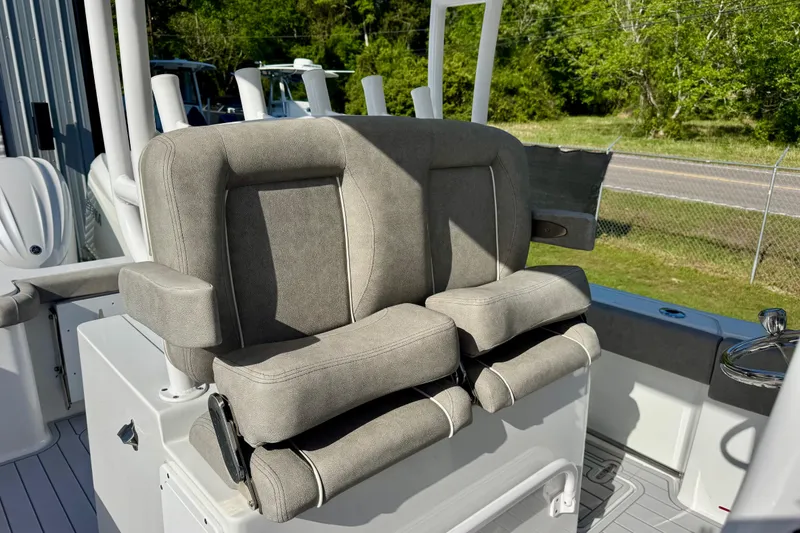 Slide: The Image of 2024 Sea Hunt Gamefish 28 Coffin Box boat seating, featuring plush gray upholstery. - 13