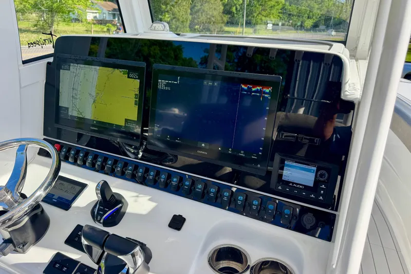 Slide: The Image of 2024 Sea Hunt Gamefish 28 Coffin Box dashboard with dual Garmin displays and controls. - 15