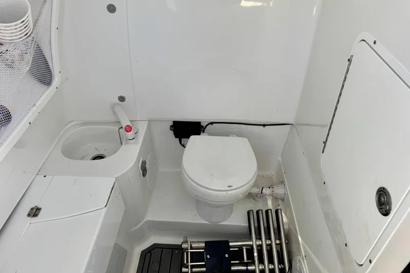 Slide: The Image of 2024 Sea Hunt Gamefish 28 Coffin Box boat interior with toilet and sink. - 18