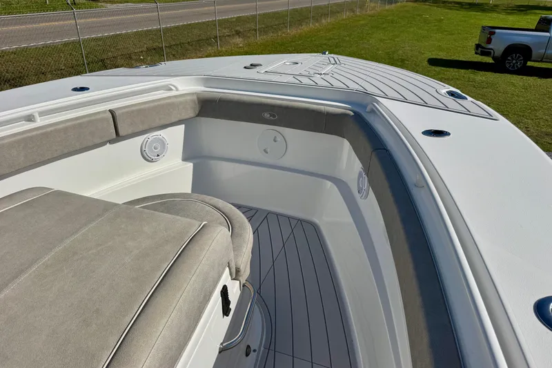 Slide: The Image of 2024 Sea Hunt Gamefish 28 Coffin Box boat interior with cushioned seating and speaker system. - 6
