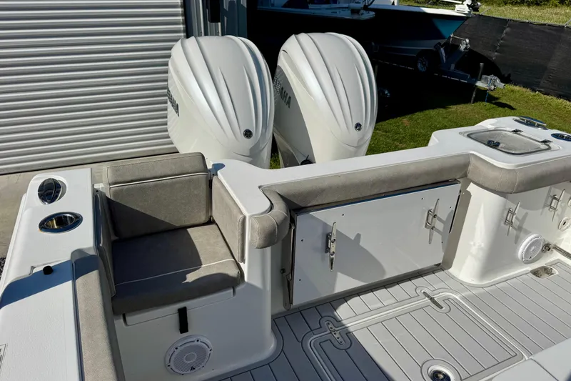 Slide: The Image of 2024 Sea Hunt Gamefish 28 Coffin Box boat with dual engines and cushioned seating. - 9