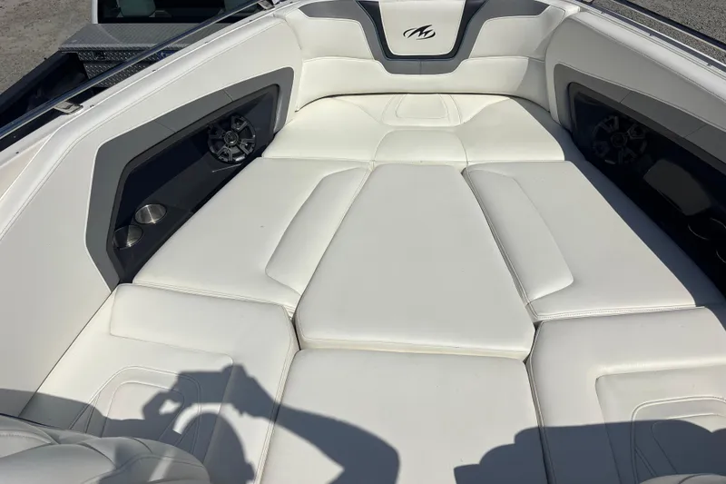 Slide: The Image of Luxurious white seating on 2014 Monterey 328SS Super Sport boat, featuring cup holders and speakers. - 13