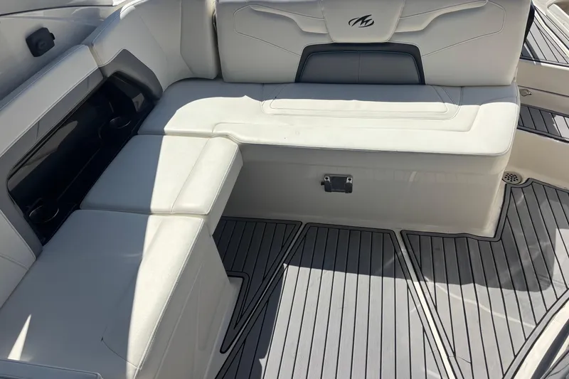 Slide: The Image of 2014 Monterey 328SS Super Sport boat interior with white seating and sleek flooring. - 8