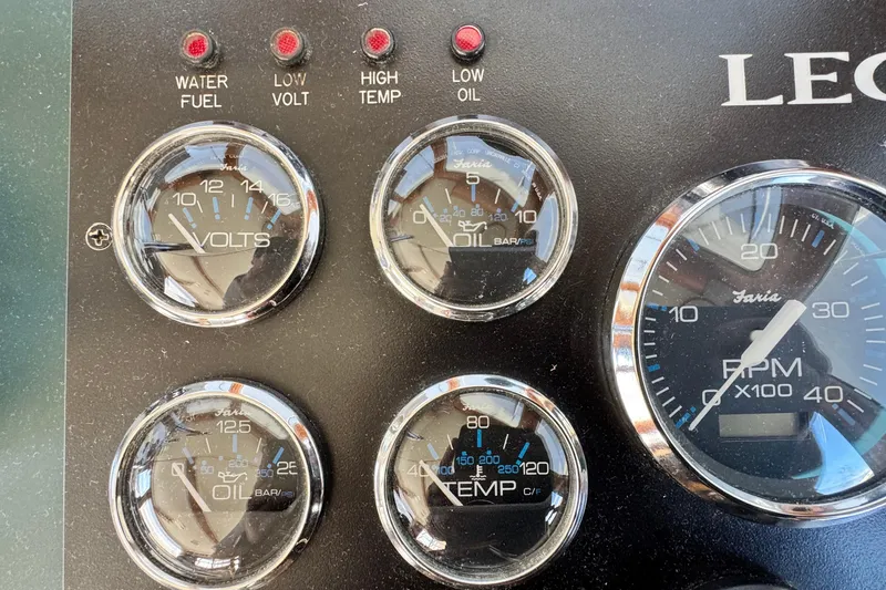 Slide: The Image of Instrument panel of a 1999 Legacy Yachts 40 Express, showing gauges and warning lights. - 13