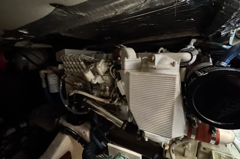 Slide: The Image of Engine compartment of a 1999 Legacy Yachts 40 Express, showcasing mechanical components. - 20
