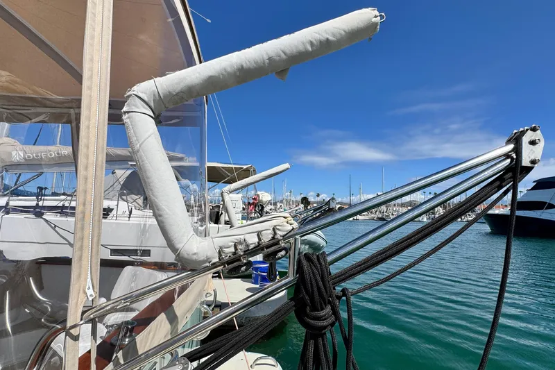 Slide: The Image of 1999 Legacy Yachts 40 Express docked in marina, showcasing rigging and clear skies. - 6