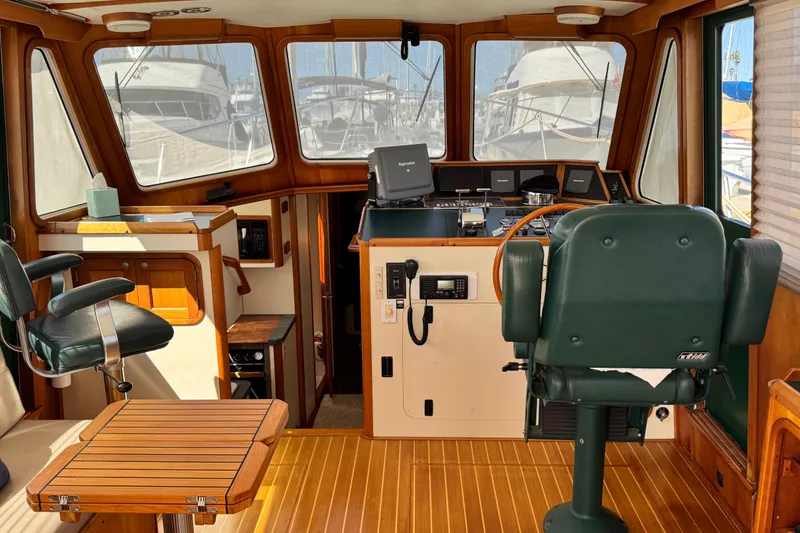 Slide: The Image of Interior of 1999 Legacy Yachts 40 Express, featuring helm and seating area. - 8