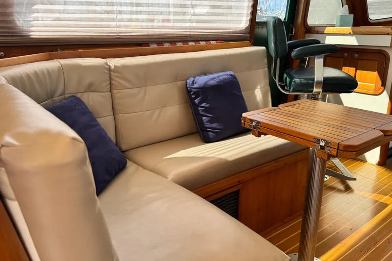 Slide: The Image of Luxurious interior of 1999 Legacy Yachts 40 Express with leather seating and wooden table. - 9