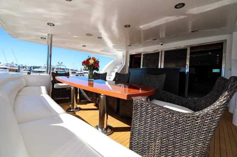 Slide: The Image of Luxurious 1996 Monte Fino Eurostyle yacht deck with elegant seating and floral centerpiece. - 13