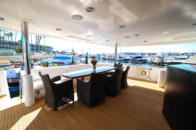 Slide: The Image of Luxurious 1996 Monte Fino Eurostyle yacht deck with elegant seating and marina view. - 14