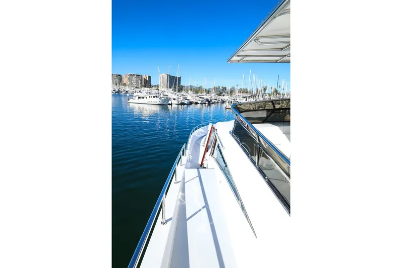 Slide: The Image of Monte Fino Eurostyle 1996 yacht docked in a marina under clear blue skies. - 4