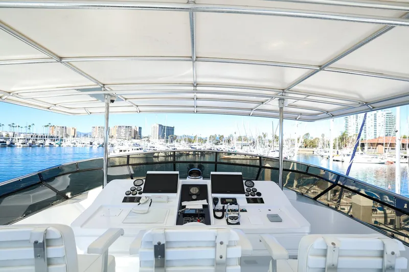 Slide: The Image of Cockpit view of 1996 Monte Fino Eurostyle yacht in marina, showcasing controls and waterfront. - 6