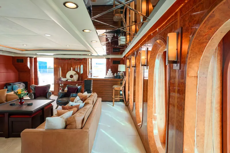 Slide: The Image of Luxurious interior of 1996 Monte Fino Eurostyle yacht with elegant wood paneling and plush seating. - 8