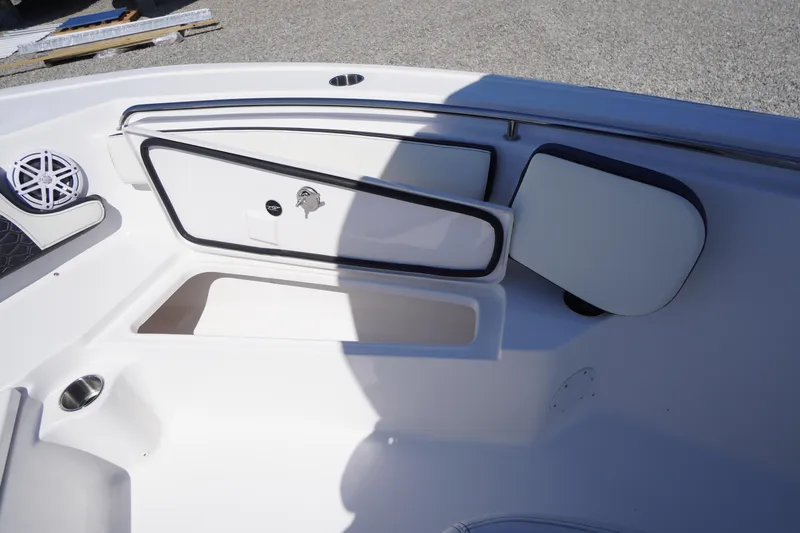 Slide: The Image of 2025 Tidewater 210 LXF boat interior with open storage compartments and speaker. - 11