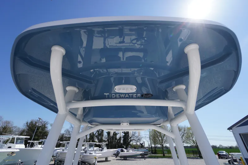 Slide: The Image of 2025 Tidewater 210 LXF boat, blue hull, viewed from below, sunny day. - 14